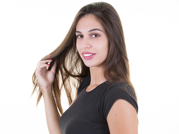 Smiling brunette young woman hand on hair head on white background