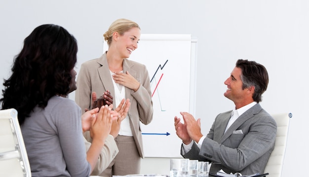 Smiling business people applauding a good presentation