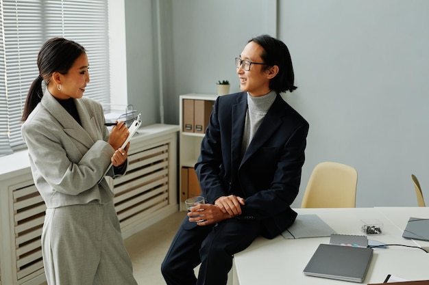 Smiling Business People Chatting in Office