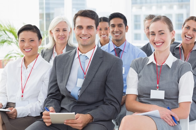 Smiling business people looking at camera during meeting 