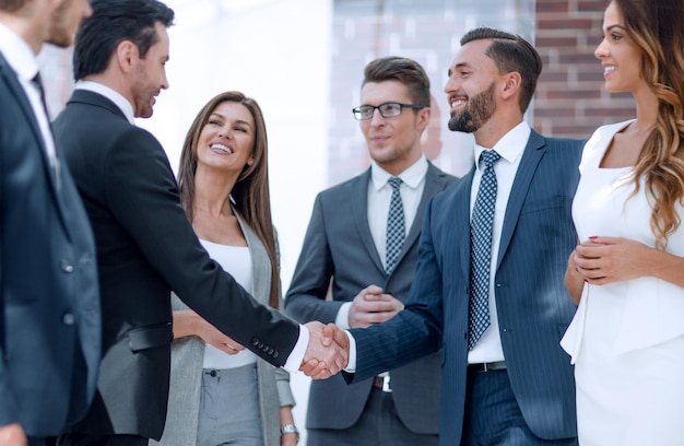 Smiling business people shaking hands with each other