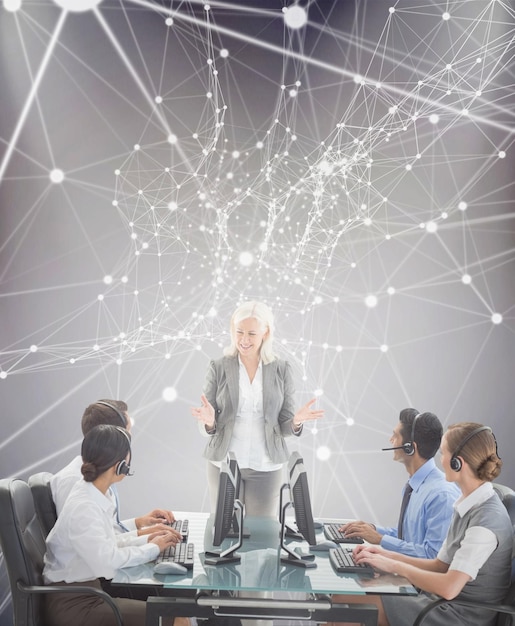 Smiling business people speaking together  against grey background