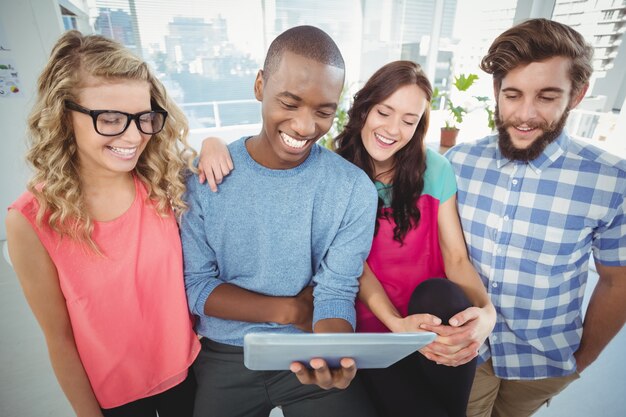 Smiling business people using tablet