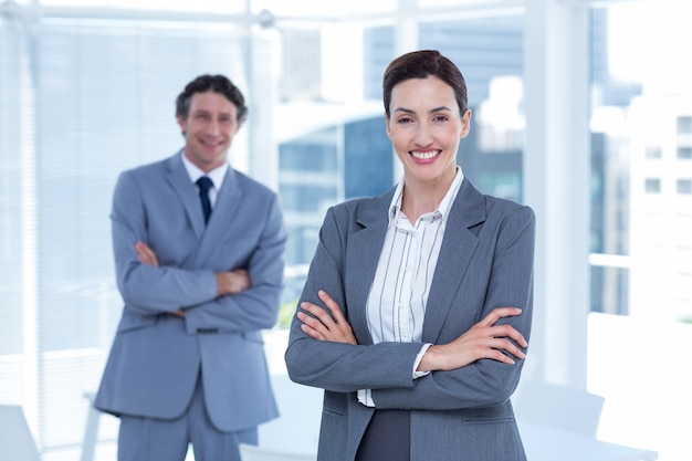 Smiling business people with arms crossed