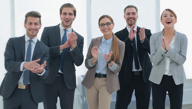 Smiling business team applauds their successthe concept of teamwork