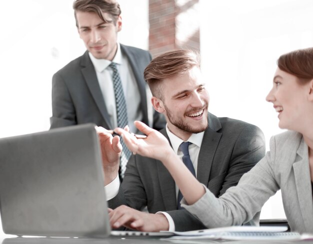 Smiling business team discussing online newspeople and technology