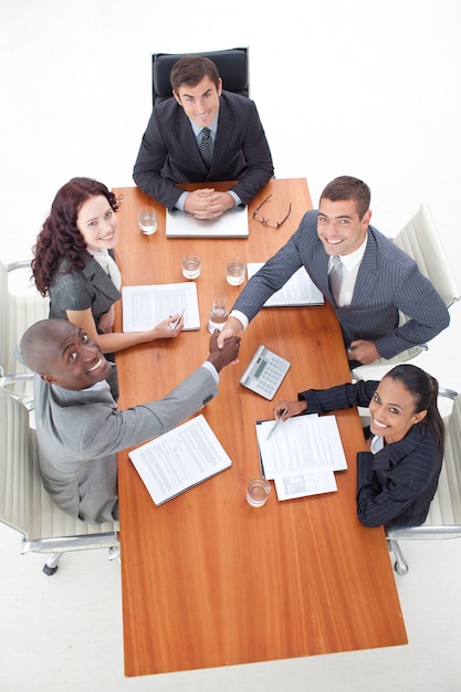 Smiling business team shaking hand