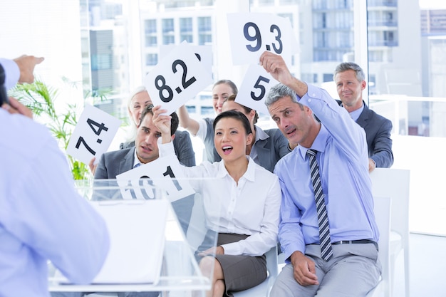 Photo smiling business team showing paper with rating