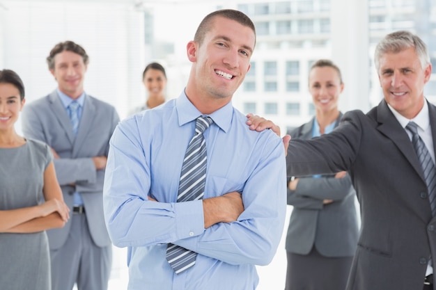 Smiling business team standing with arms crossed