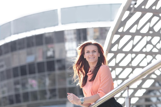 Smiling business woman on background of office building