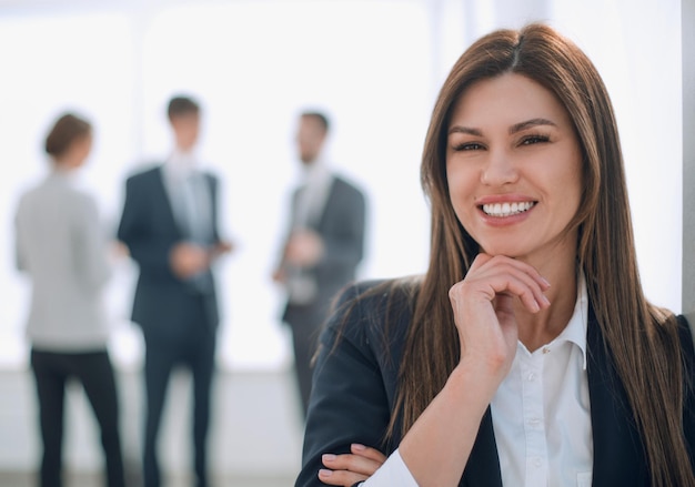 Smiling business woman on blurred office background