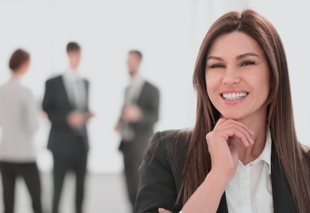 Smiling business woman on blurred office background