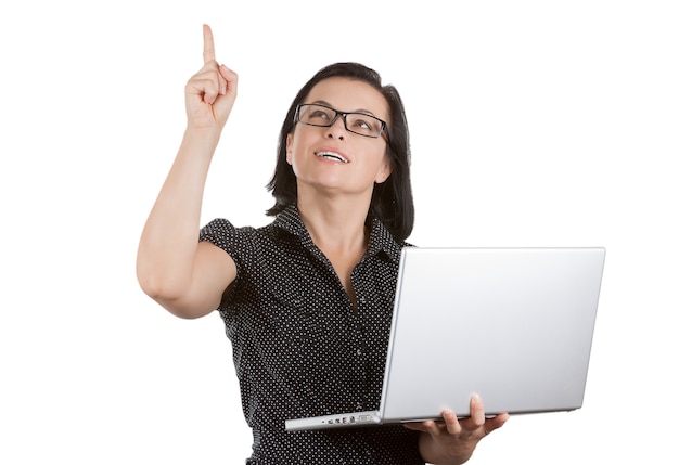 Smiling Business Woman in Glasses Working on Laptop and Point to Blank Space for Yours Design on a white background