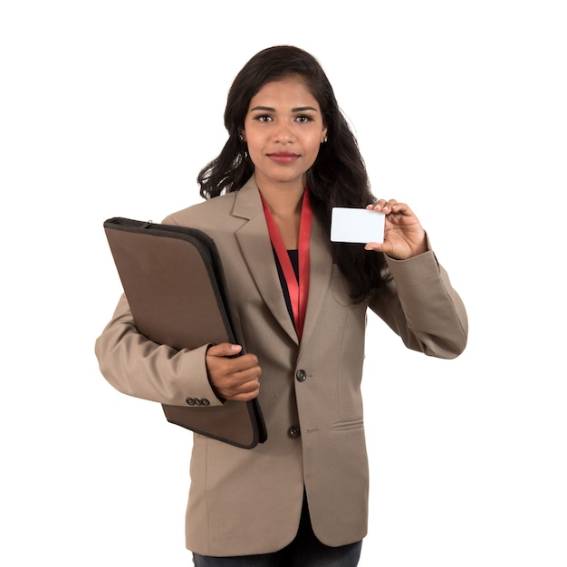 Smiling business woman holding a blank business card or id card over white background