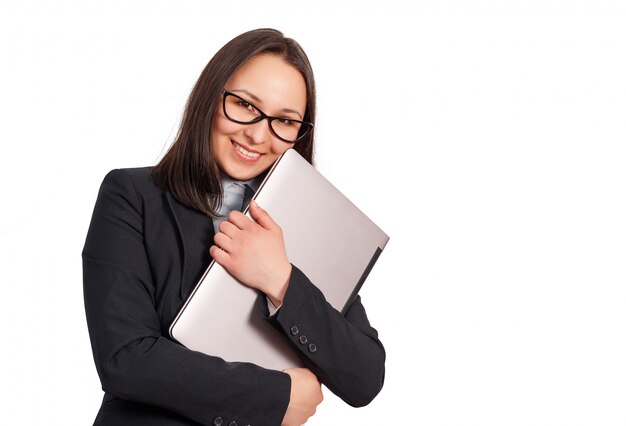 Smiling business woman in a jacket and glasses, with a laptop in her hands.