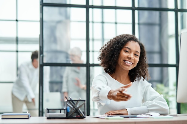 Smiling business woman pointing at you closeup