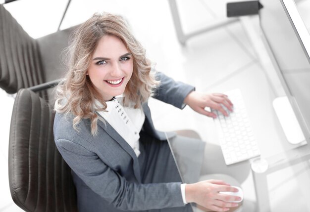 Smiling business woman sitting behind a Desk