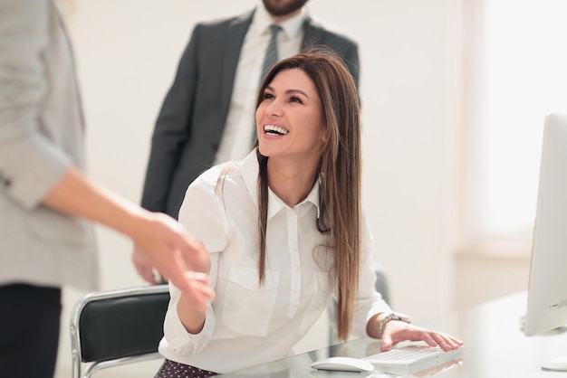 Smiling business woman talking to colleagues