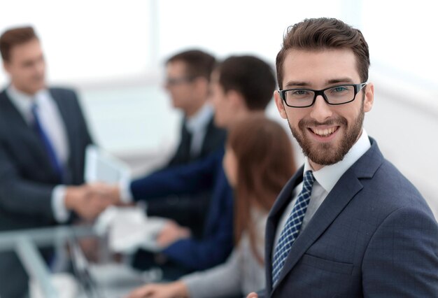 Smiling businessman on background of office