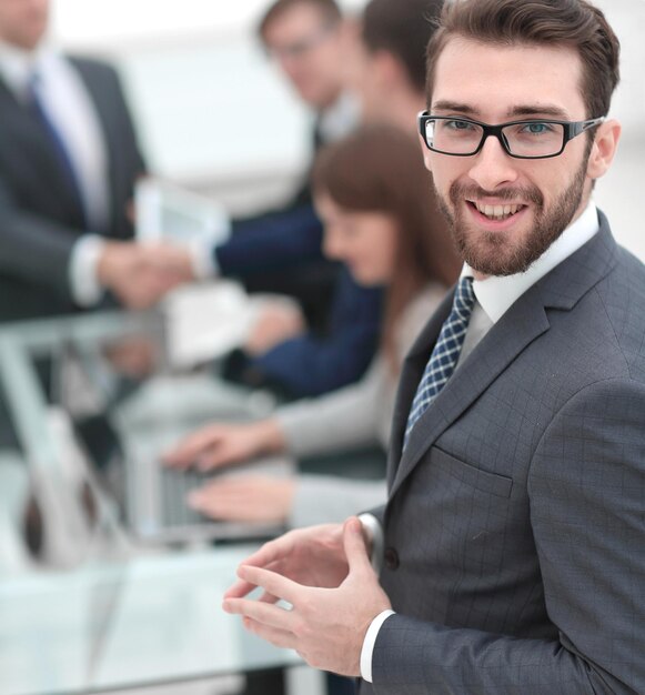 Smiling businessman on background of office