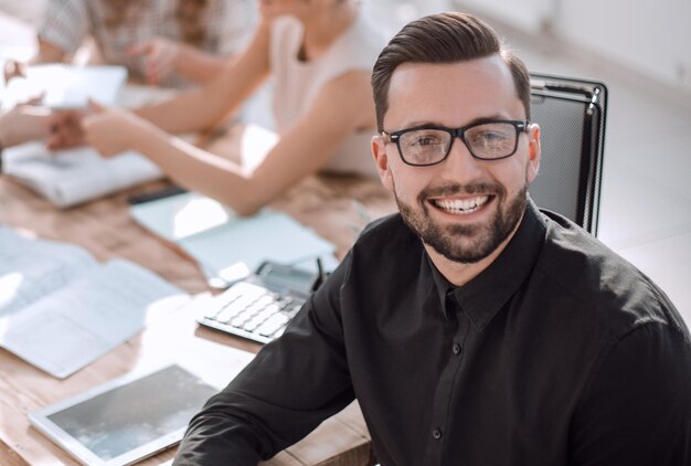 Smiling businessman in the background of the office