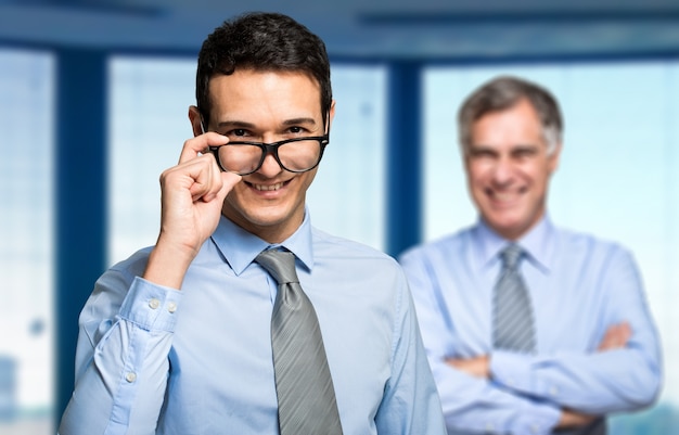 Smiling businessman in front of his boss