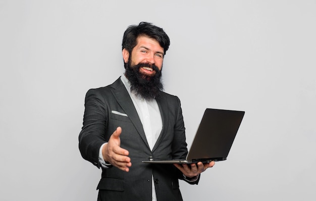 Smiling businessman going to handshake successful business handshake concept businessman holds