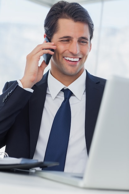 Smiling businessman having a phone call