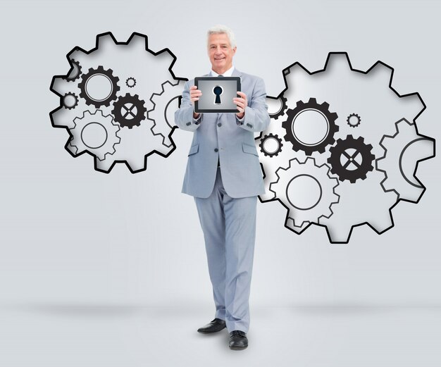 Photo smiling businessman holding a tablet against a background