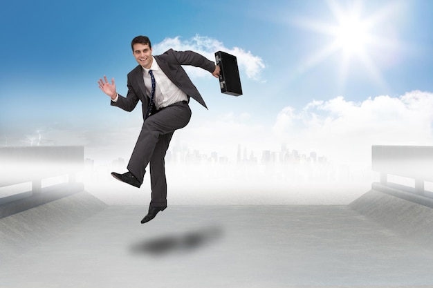 Smiling businessman in a hurry against cityscape on the horizon