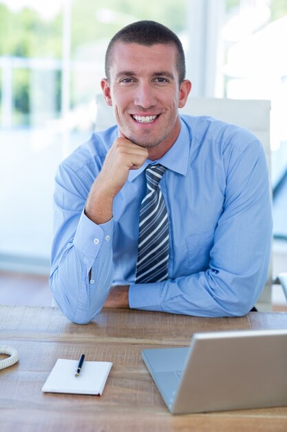 Smiling businessman looking at camera