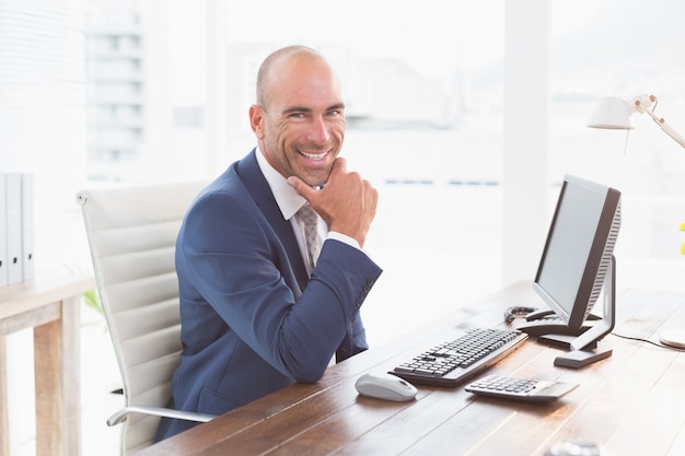 Smiling businessman looking at camera