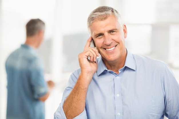 Smiling businessman on the phone