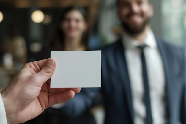 Smiling Businessman Presenting Blank Business Card in Office Environment