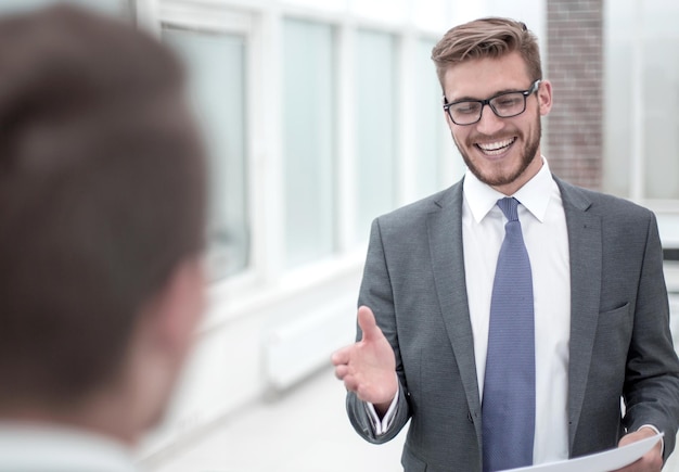 Smiling businessman reaching out for a handshake