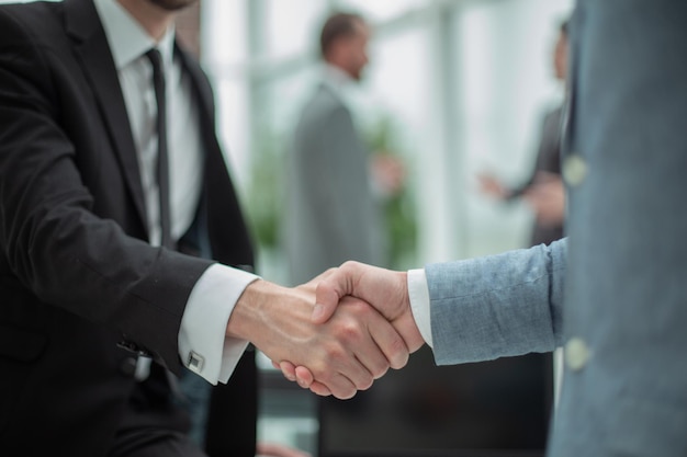 Smiling businessman shaking hands with his business partner