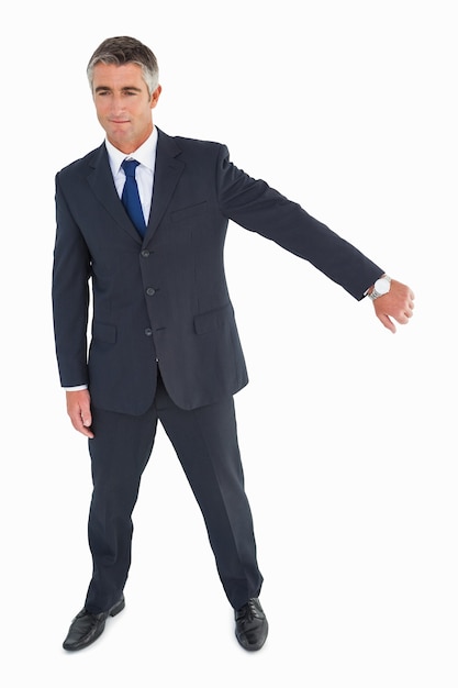 Smiling businessman showing his wrist time