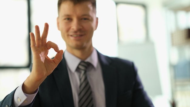 Smiling businessman showing ok sign