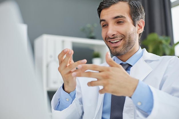 Smiling businessman standing greeting partner with handshake