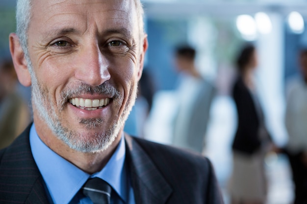 Smiling businessman standing at office