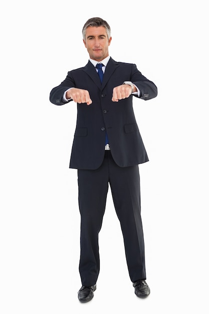 Smiling businessman in suit gesturing 