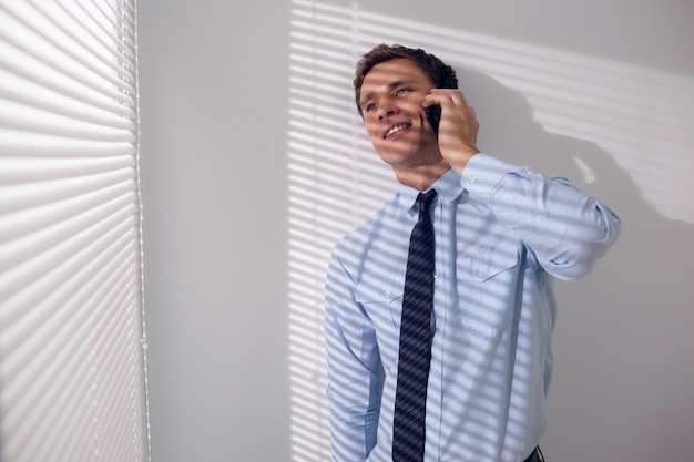 Smiling businessman using mobile phone