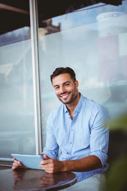 Smiling businessman using a tablet