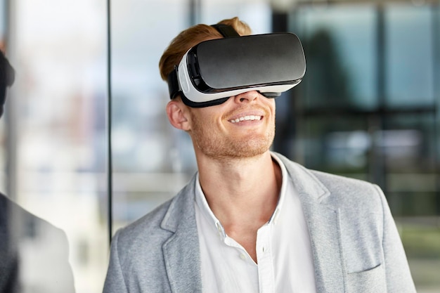 Smiling businessman wearing VR glasses