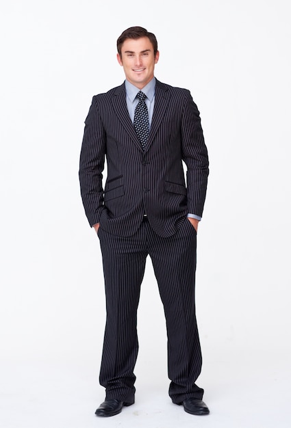 Smiling businessman with his hands in his pockets