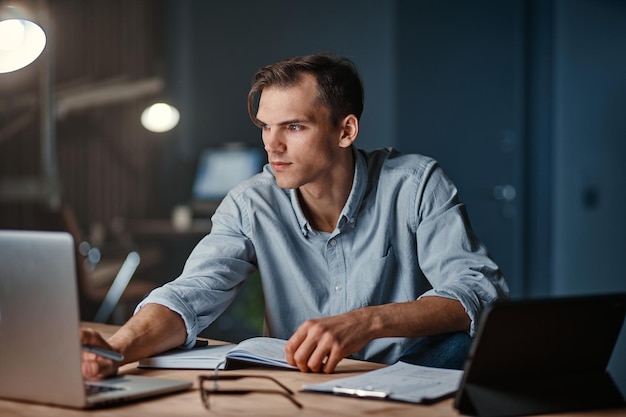 Smiling businessman working on a new project at night