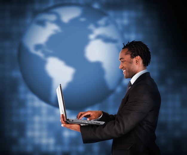 Smiling businessman working with laptop