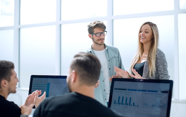 Smiling businessmen talking about eligible investment manager presenting financial report showing good work results to satisfied boss pointing on paper offering deal discussing new project