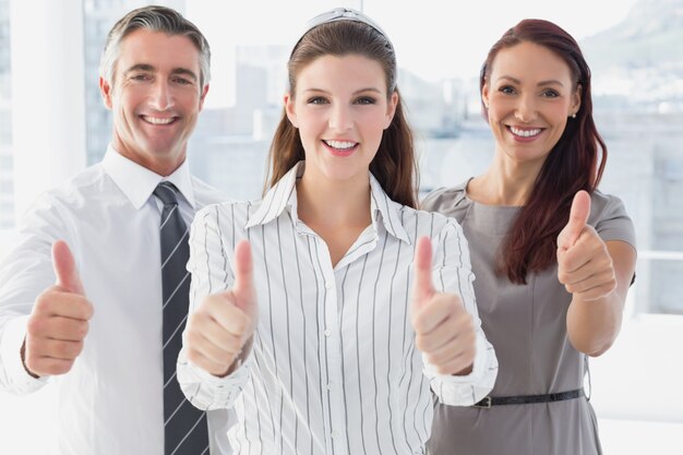 Smiling businesswoman giving thumbs up