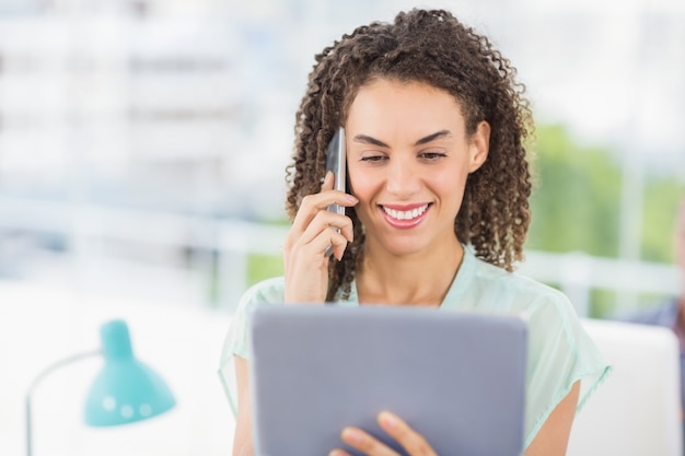 Smiling businesswoman holding a tablet